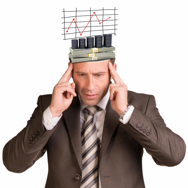 Thoughtful businessman looking down with graph and money in his head on isolated white background